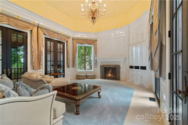 a living room with furniture chandelier and a chandelier