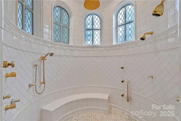 a living room with furniture gym equipment and large windows