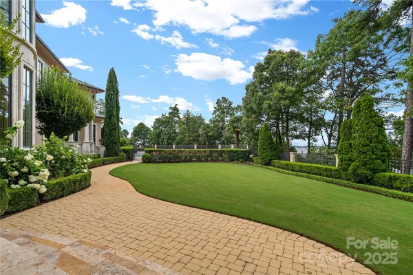 a aerial view of a house with outdoor space and a lake view in back