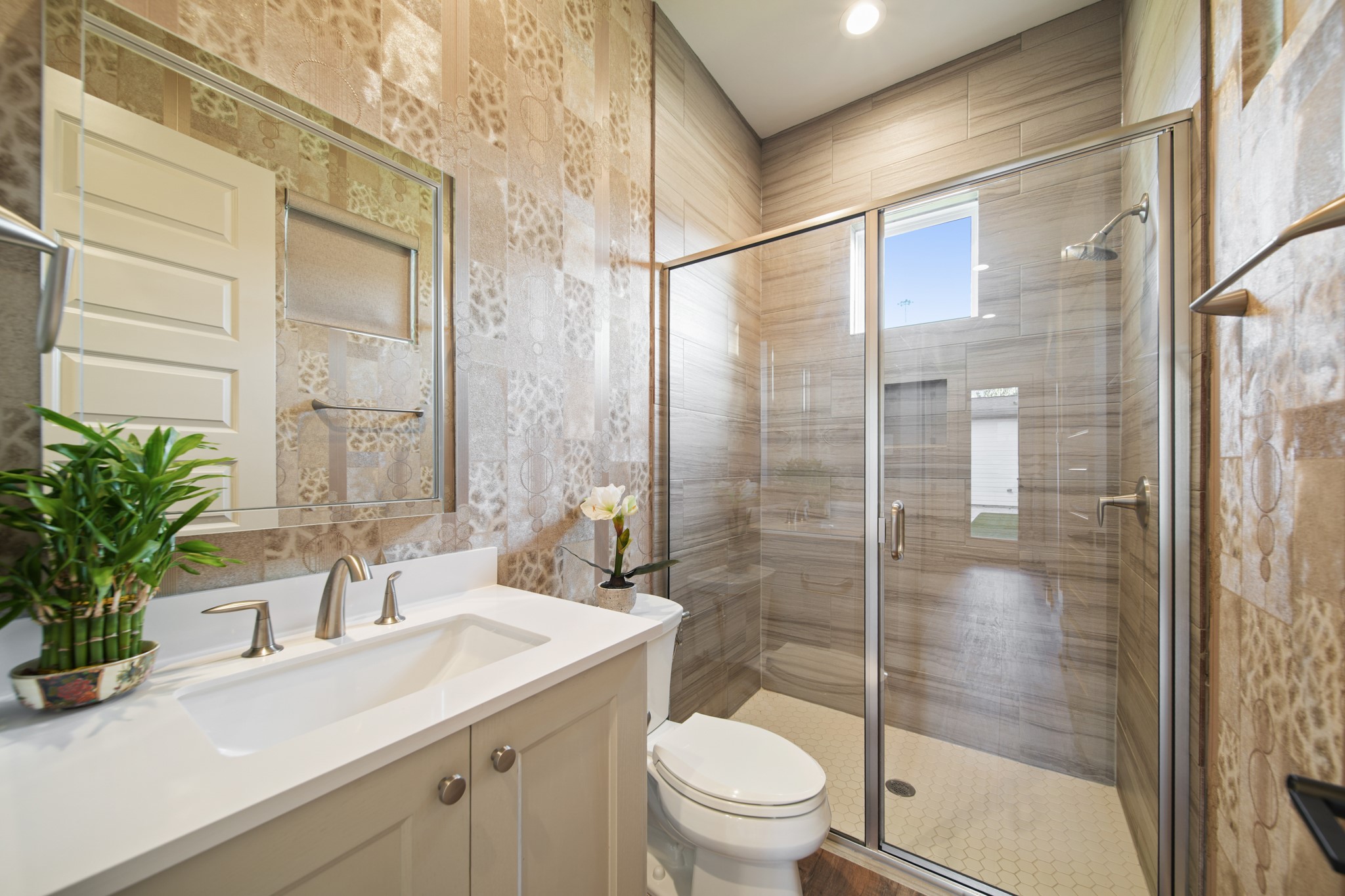 5434 Windswept Lane Houston, TX 77056 - Photo 11 of 45 This bathroom is located downstairs, just outside a secondary bedroom, and it has a stunning walk-in shower, and great detailing around.