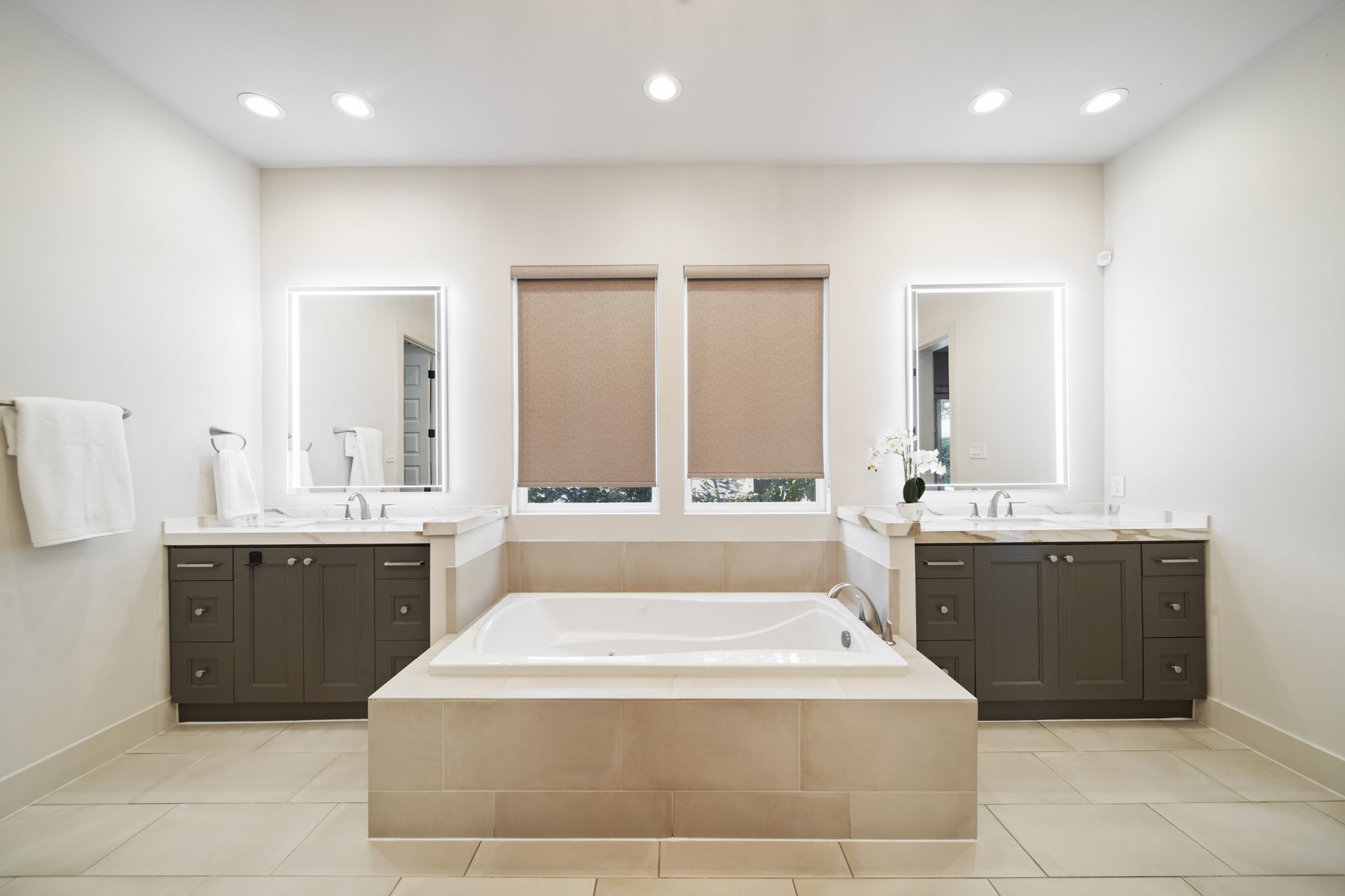 5434 Windswept Lane Houston, TX 77056 - Photo 22 of 45 An artful and sophisticated bathroom retreat, complete with a freestanding tub, dual vanities, large mirrors, tile flooring, and luminous windows for a truly luxurious ambiance.