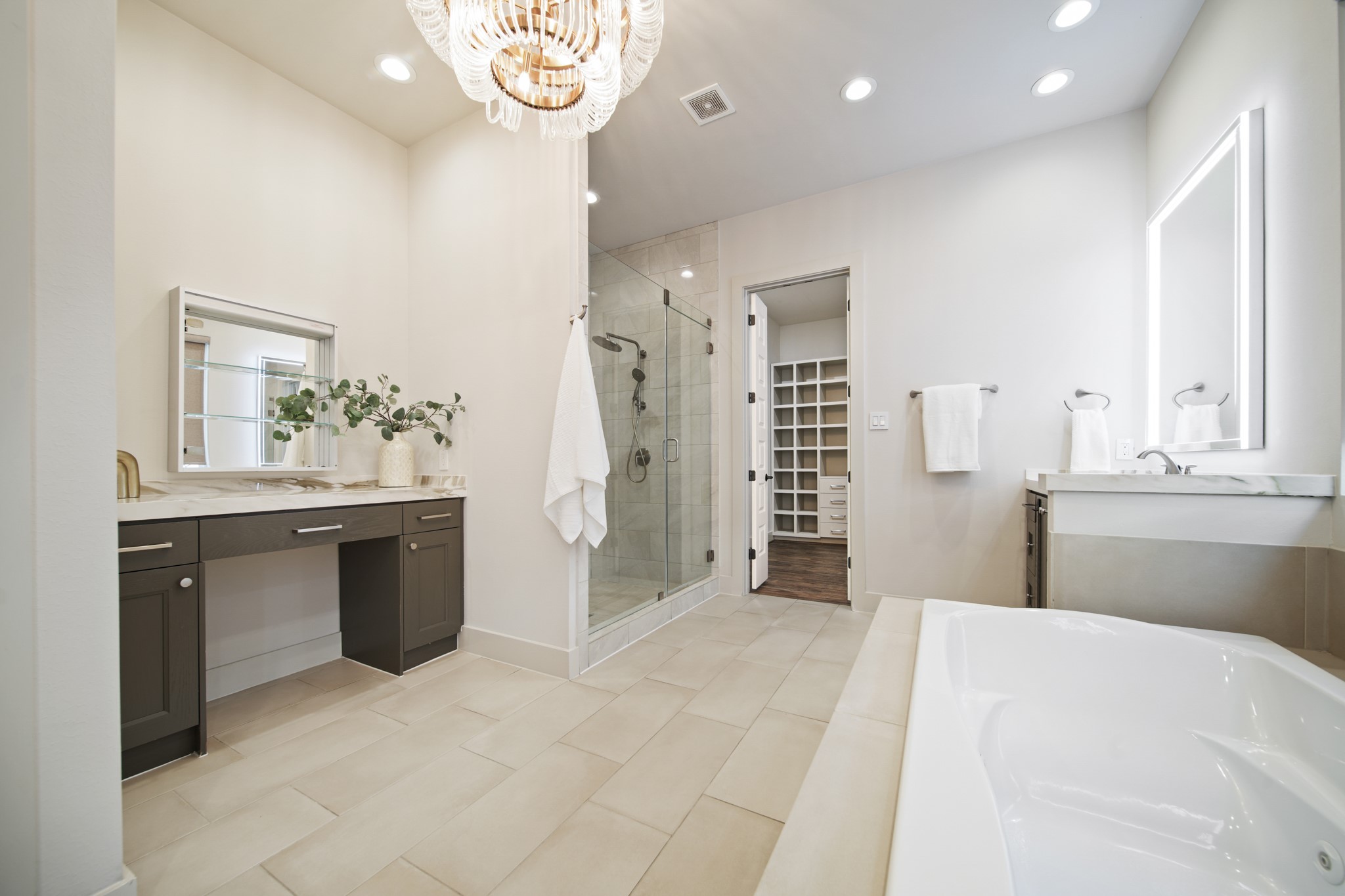 5434 Windswept Lane Houston, TX 77056 - Photo 24 of 45 A spa-like primary bathroom featuring dual vanities, a seamless glass walk-in shower, and a soaking tub with jets.