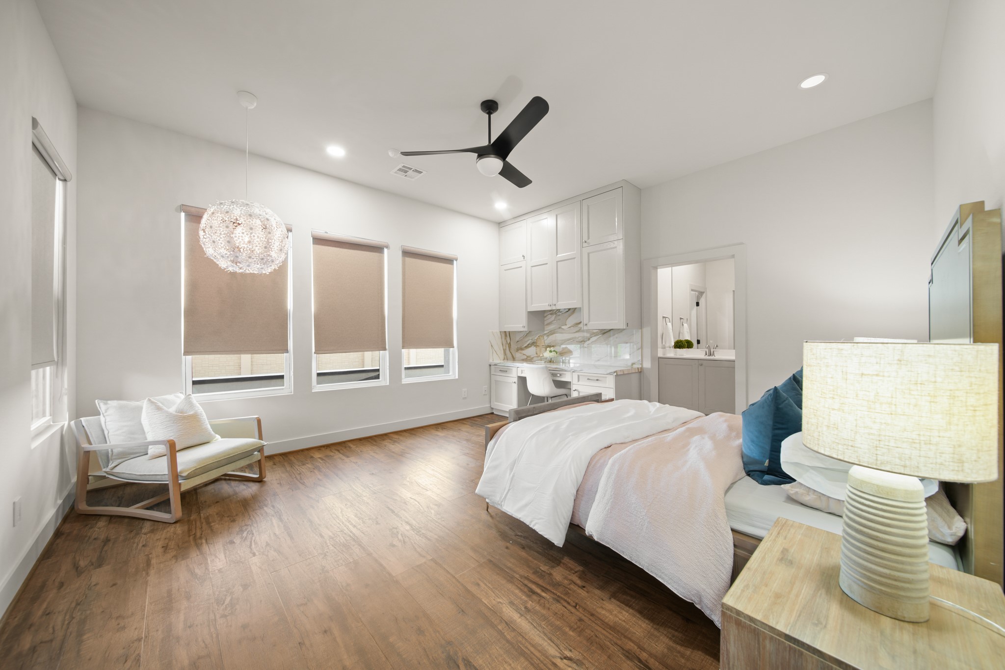 5434 Windswept Lane Houston, TX 77056 - Photo 34 of 45 This secondary bedroom has it all! The wooden floors, the large windows, recessed lighting, a ceiling fan, a seating space, as well as a personal office space. It also has its own en-suite bath.