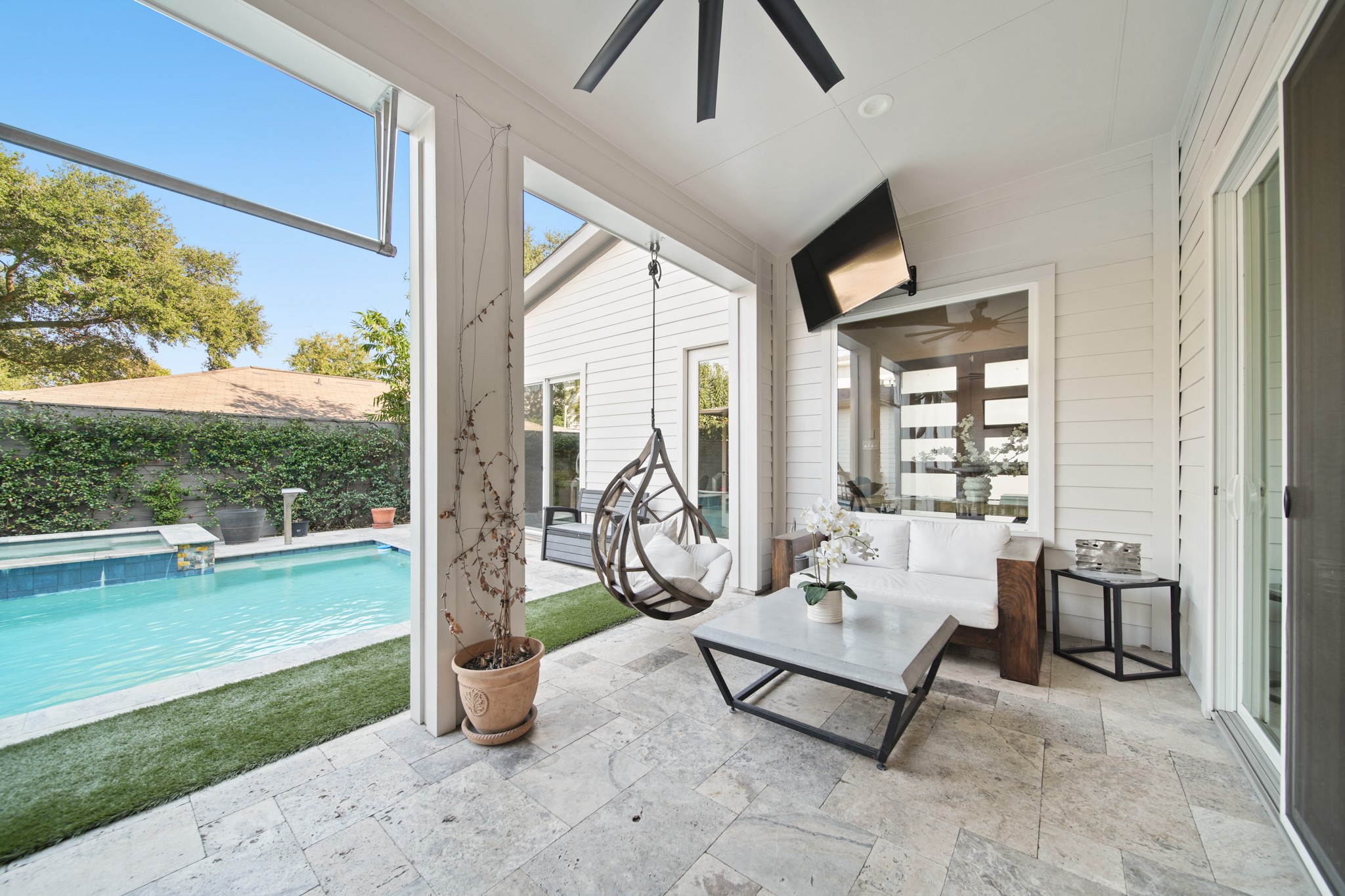 5434 Windswept Lane Houston, TX 77056 - Photo 42 of 45 This covered patio is the perfect place to watch the gorgeous Texas sunset from this stunning backyard! It includes a ceiling fan to keep you cool in the hotter months.