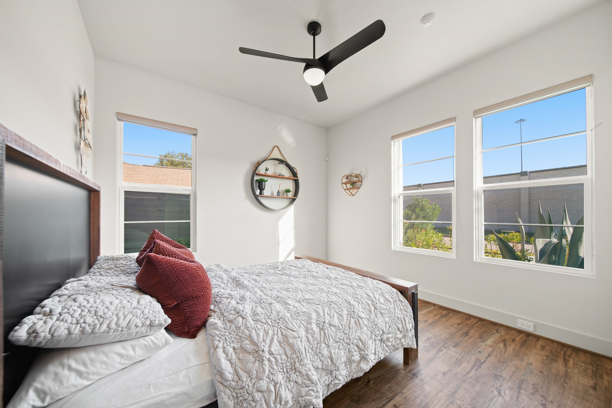 5434 Windswept Lane Houston, TX 77056 - Photo 9 of 45 Secondary bedroom with wood floors, and a dark stained ceiling fan.