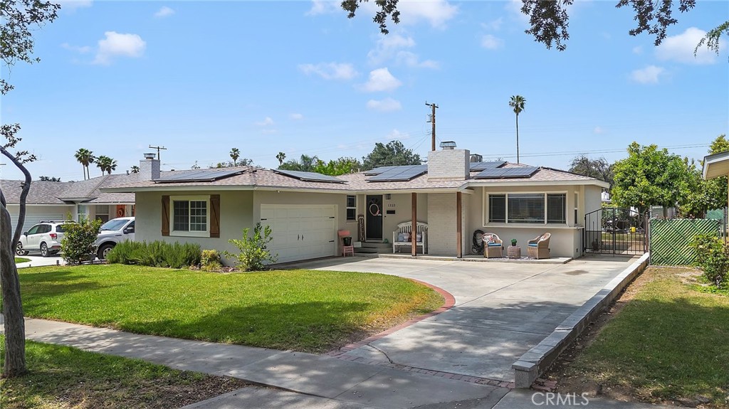 a view of a house with backyard sitting area and garden