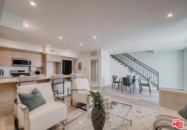 a kitchen with a sink a stove and cabinets