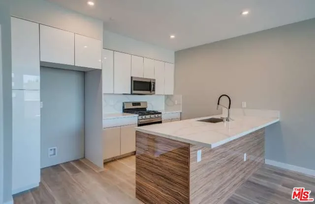a kitchen with stainless steel appliances a refrigerator stove and sink
