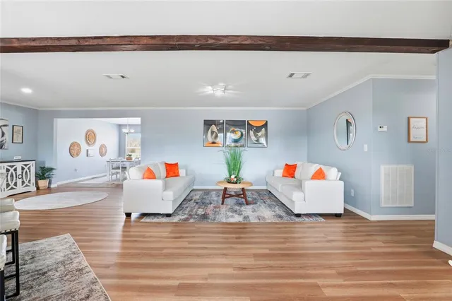 a kitchen with stainless steel appliances kitchen island granite countertop a stove a sink and a white cabinets