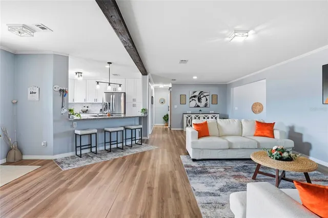 a kitchen with stainless steel appliances white cabinets and a wooden floor