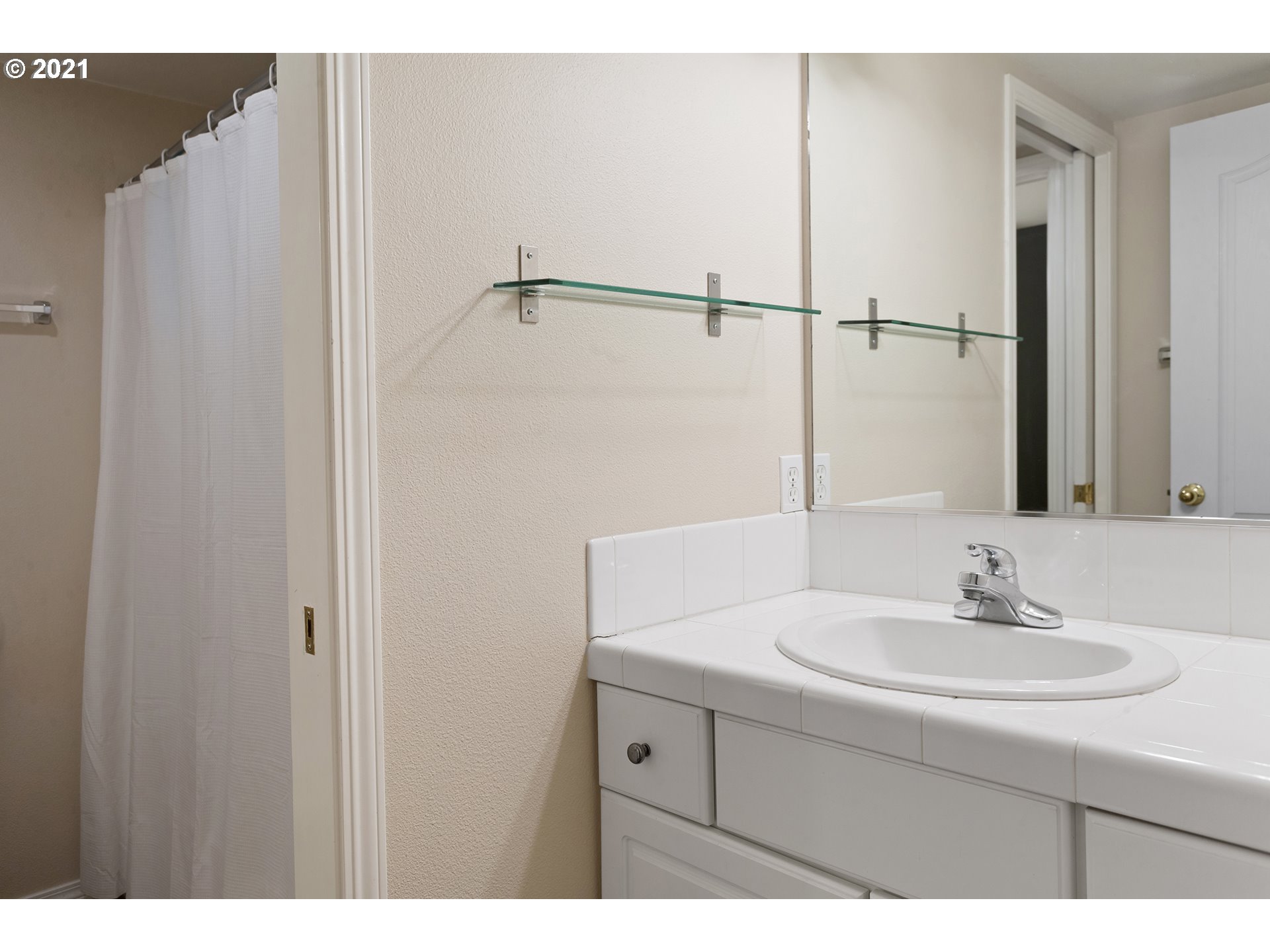 4930 Southwest 1st Avenue Portland, OR 97239 - Photo 18 of 27 a bathroom with a sink and a mirror