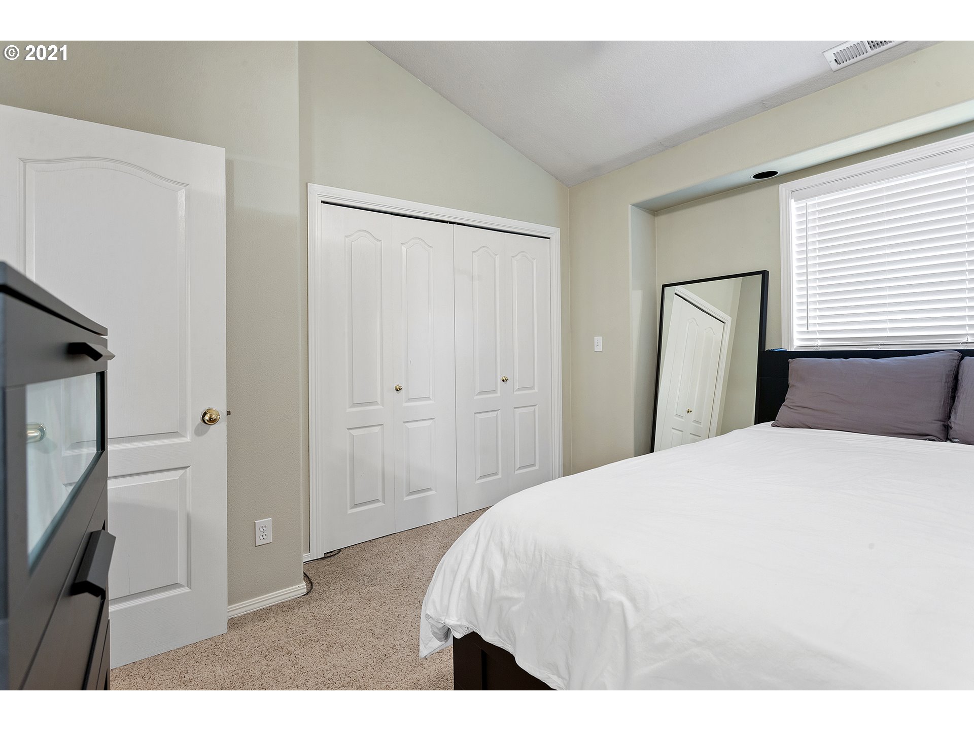 4930 Southwest 1st Avenue Portland, OR 97239 - Photo 19 of 27 a bedroom with a bed and a refrigerator