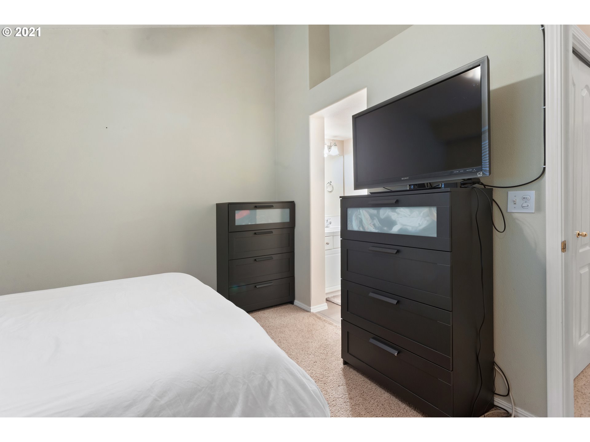 4930 Southwest 1st Avenue Portland, OR 97239 - Photo 21 of 27 a bedroom with a bed and a flat screen tv