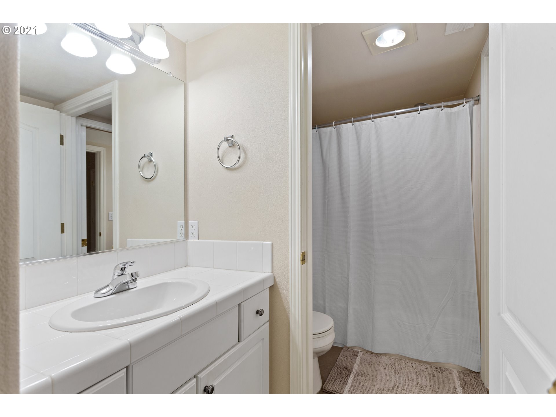 4930 Southwest 1st Avenue Portland, OR 97239 - Photo 23 of 27 a bathroom with a sink and a mirror