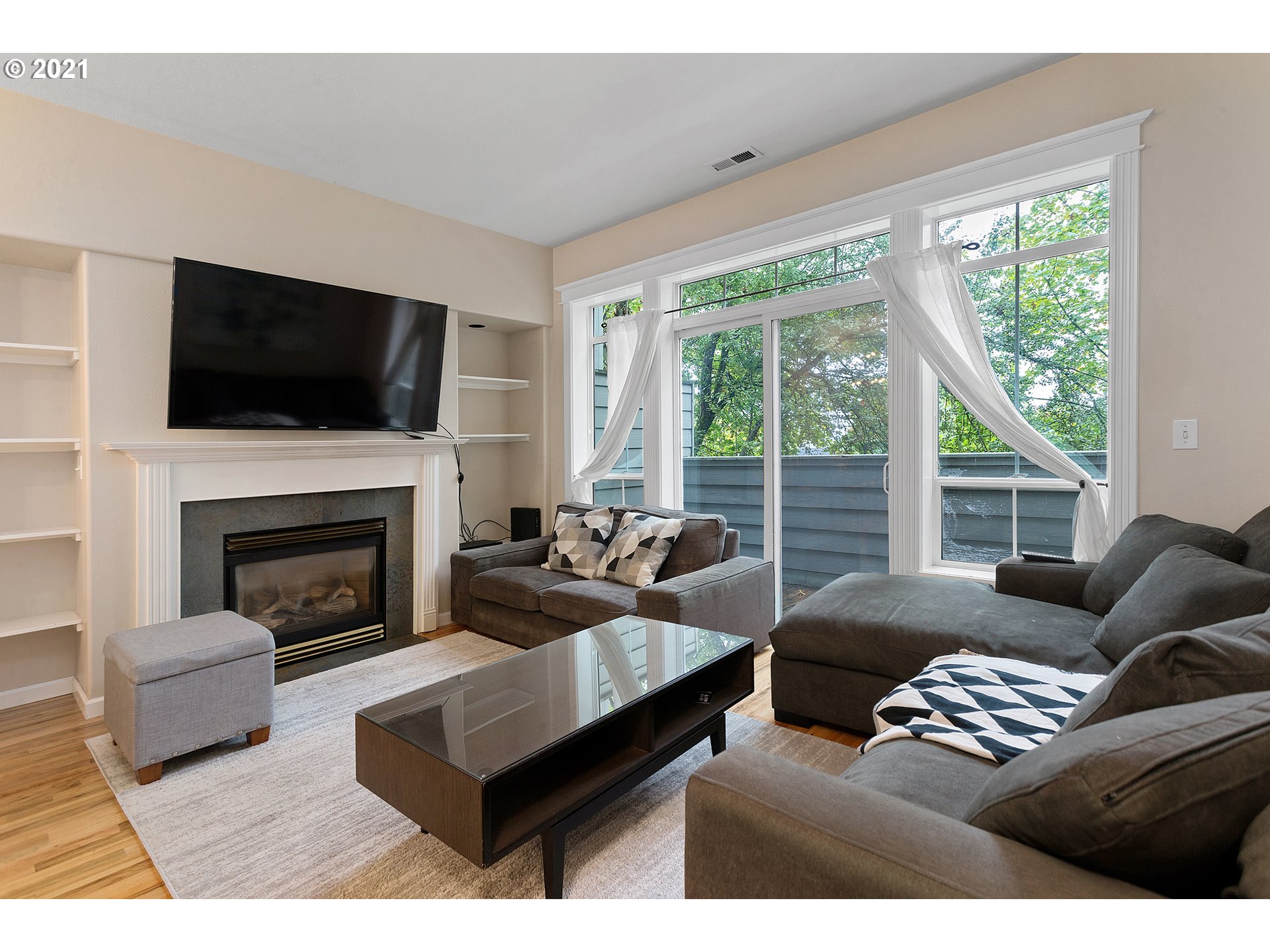 4930 Southwest 1st Avenue Portland, OR 97239 - Photo 6 of 27 a living room with furniture a large window and a fireplace