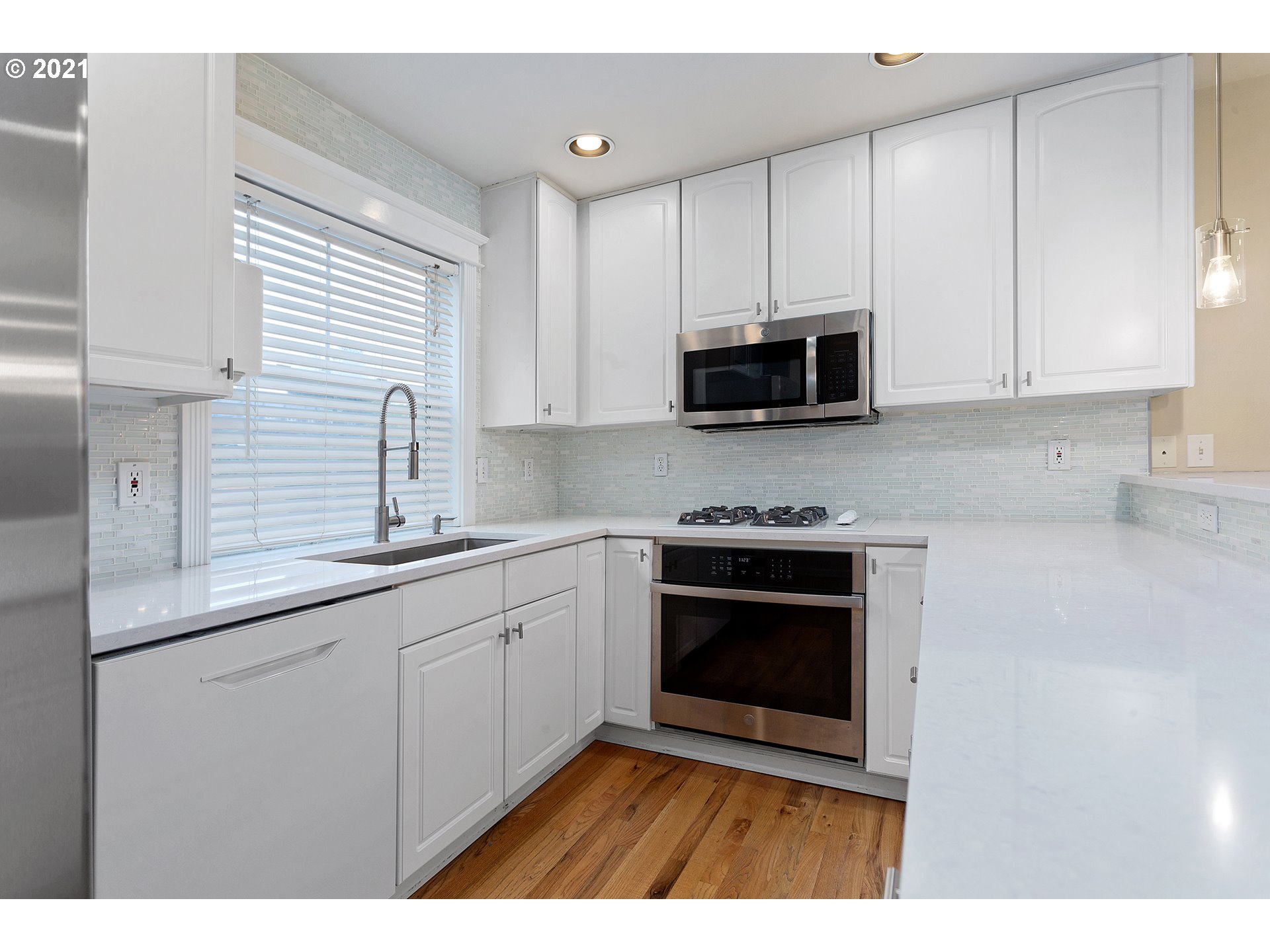 4930 Southwest 1st Avenue Portland, OR 97239 - Photo 8 of 27 a kitchen with stainless steel appliances granite countertop a sink a stove a microwave and cabinets