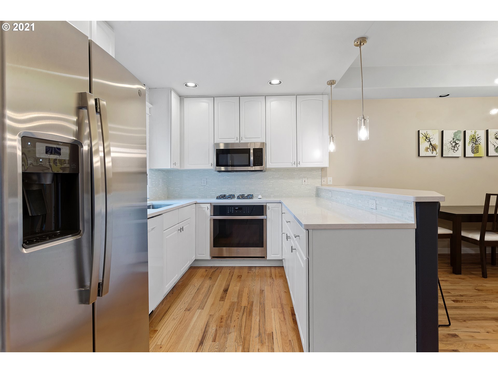 4930 Southwest 1st Avenue Portland, OR 97239 - Photo 9 of 27 a kitchen with kitchen island a counter top space stainless steel appliances and cabinets