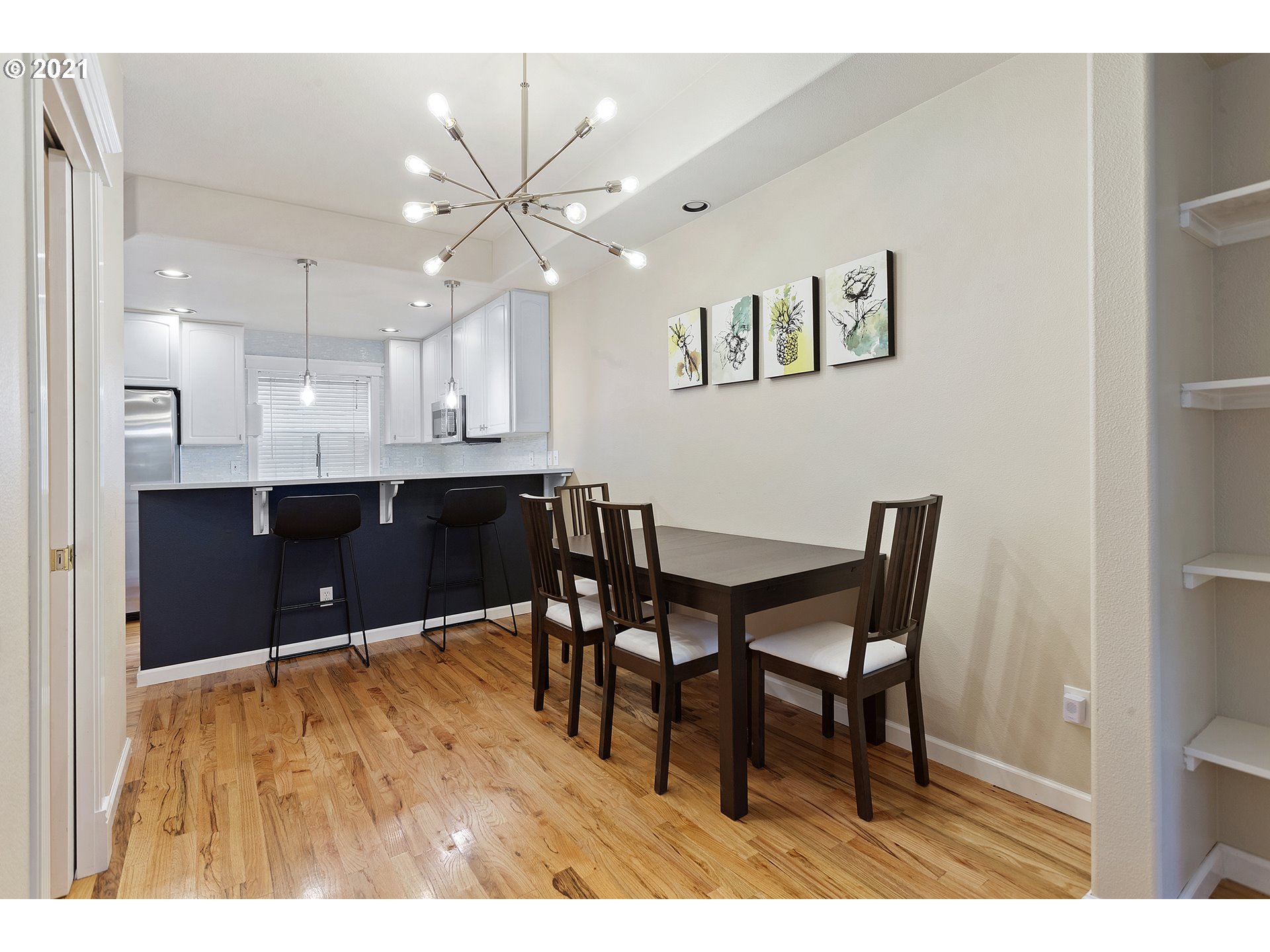 4930 Southwest 1st Avenue Portland, OR 97239 - Photo 10 of 27 a view of a dining room with furniture and wooden floor