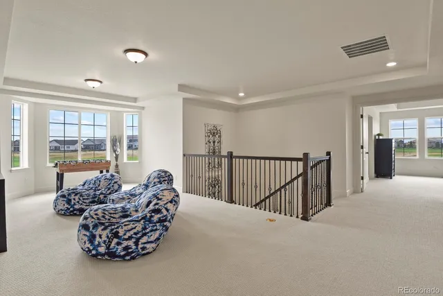 a living room with furniture floor to ceiling window and a couch