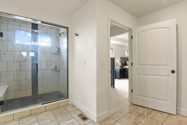 a bathroom with a glass shower door