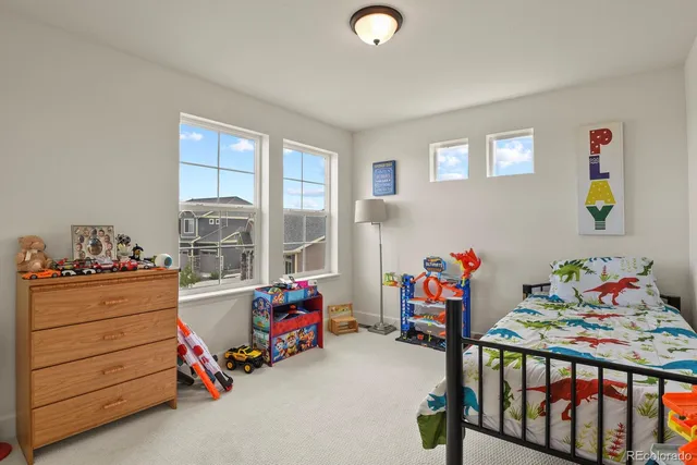 a kids bedroom with a bed and a window