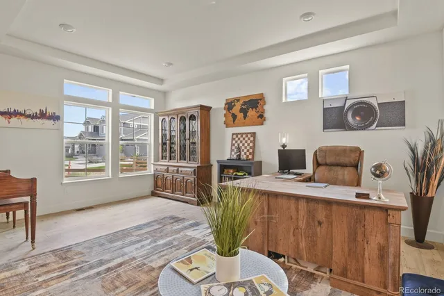 a living room with furniture a flat screen tv and a floor to ceiling window