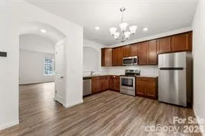 a kitchen with refrigerator a microwave and wooden floor