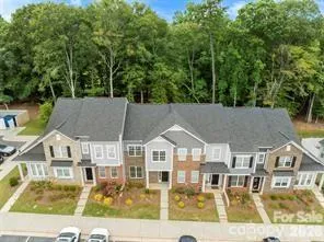 an aerial view of a residential apartment building with a yard