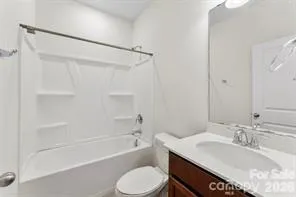 a bathroom with a sink toilet vanity and shower