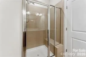 a bathroom with a glass shower door
