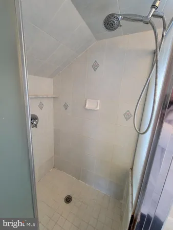 a bathroom with a glass shower door