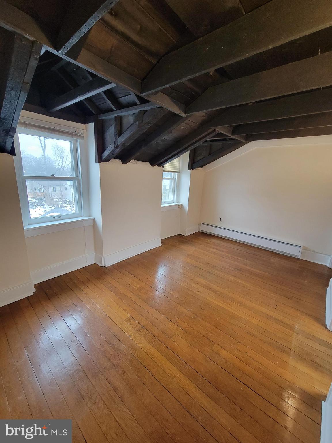 110 Gumbes Road Oaks, PA 19426 - Photo 7 of 13 a view of an empty room with wooden floor and a window