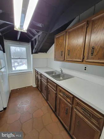 a kitchen with stainless steel appliances granite countertop a sink a stove and cabinets