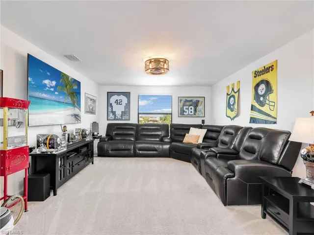 a living room with furniture window and painting on the wall