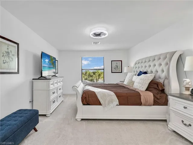 a bedroom with a bed and dresser