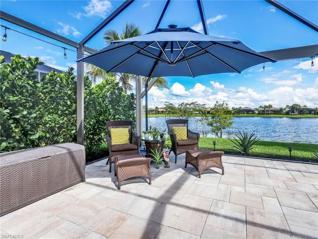 a view of a patio with furniture and a garden