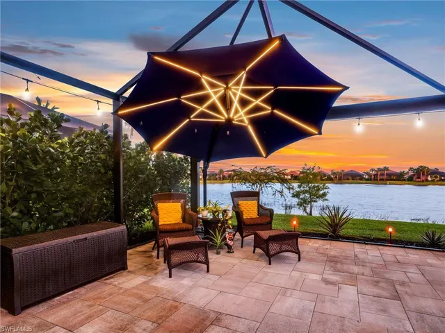 a view of a outdoor sitting area with furniture and umbrella