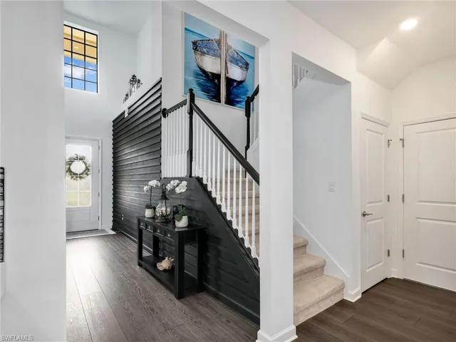 a view of entryway and hall with wooden floor