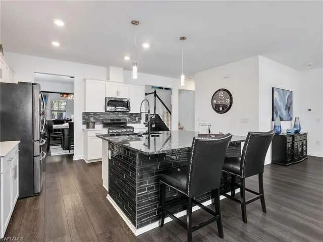 a kitchen with a table chairs and a stove