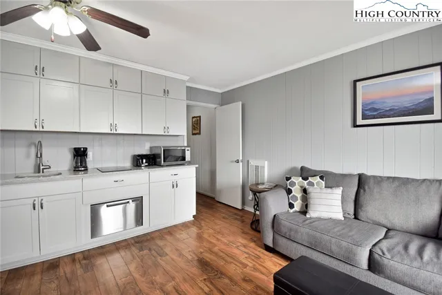 a kitchen with stainless steel appliances granite countertop a sink stove refrigerator and cabinets