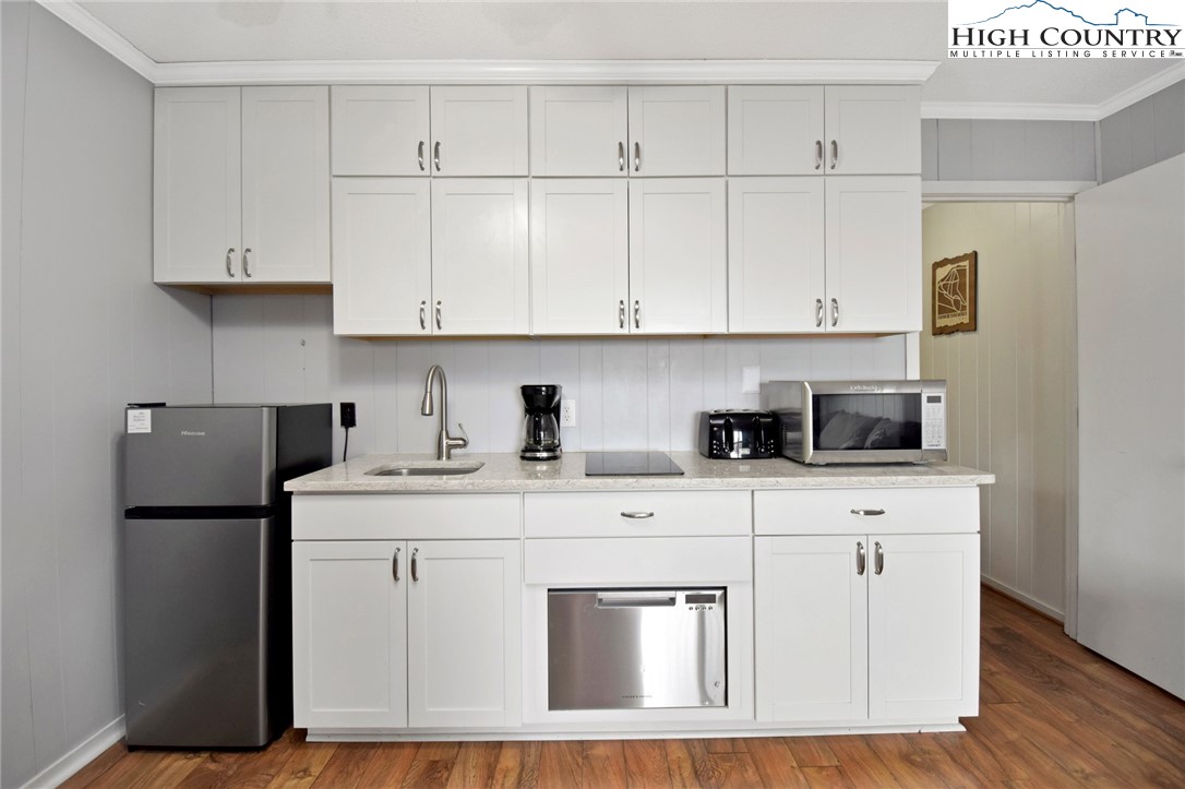 301 Pinnacle Inn Road, Unit 3130 Beech Mountain, NC 28604 - Photo 16 of 41 a kitchen with stainless steel appliances granite countertop a sink stove refrigerator and cabinets