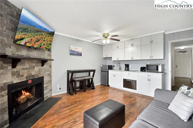 a open kitchen with furniture and a fireplace