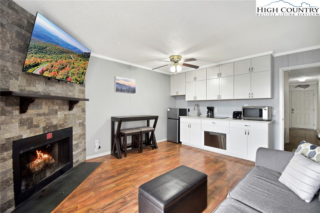 301 Pinnacle Inn Road, Unit 3130 Beech Mountain, NC 28604 - Photo 3 of 41 a open kitchen with furniture and a fireplace