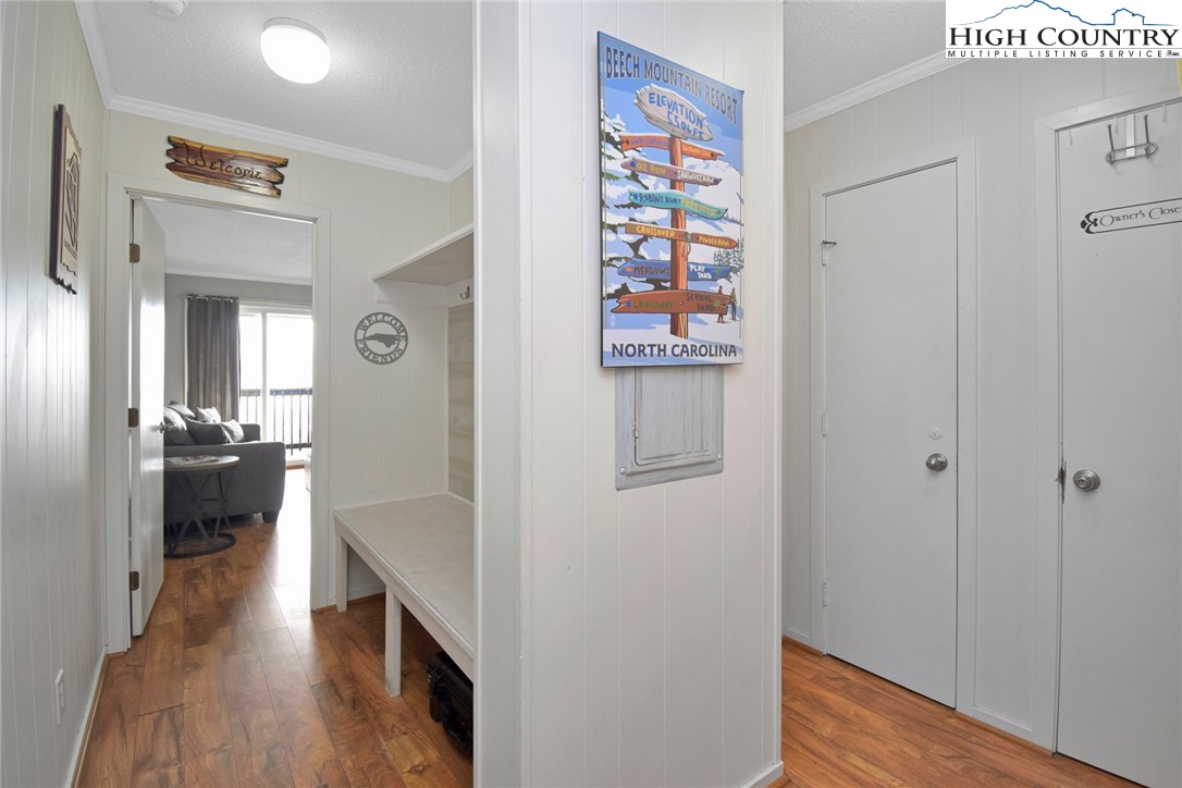 301 Pinnacle Inn Road, Unit 3130 Beech Mountain, NC 28604 - Photo 4 of 41 a view of a hallway with wooden floor and dining room