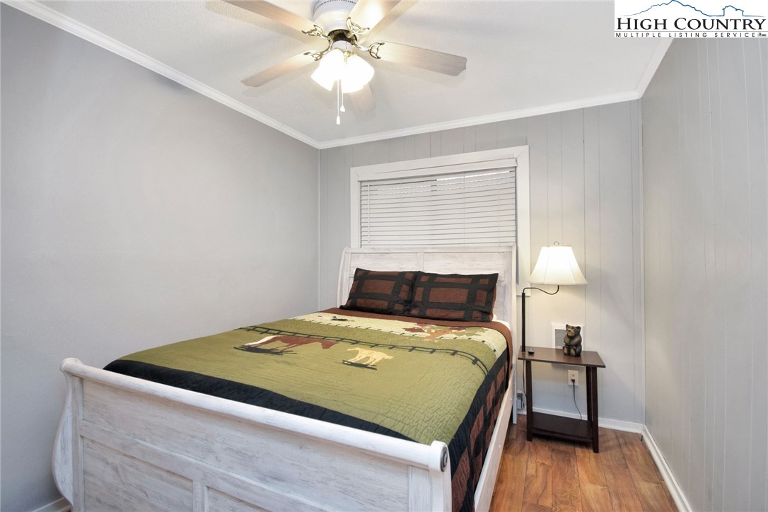 301 Pinnacle Inn Road, Unit 3130 Beech Mountain, NC 28604 - Photo 10 of 41 a bedroom with a bed and a chandelier