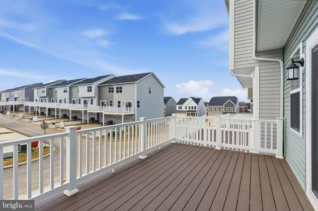 a view of a house with wooden deck