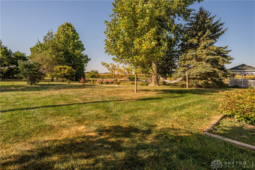 1599 Garringer Road Jamestown, OH 45335 - Photo 35 of 73 Enjoy the expansive yard with mature trees and a charming gazebo, perfect for outdoor relaxation.