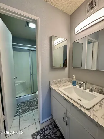 a bathroom with a sink and a mirror