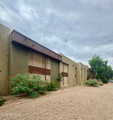 a backyard of a house with plants and trees