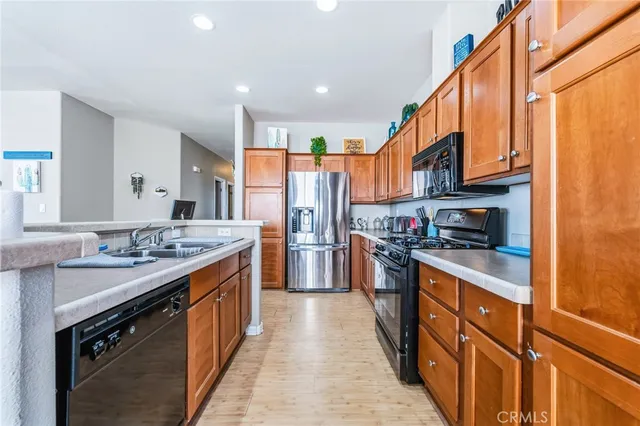 a kitchen with stainless steel appliances granite countertop a stove a sink and a refrigerator